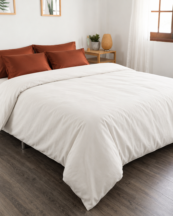Off white Plain Cotton percale bed with rust Silky Cotton sateen pillowcases