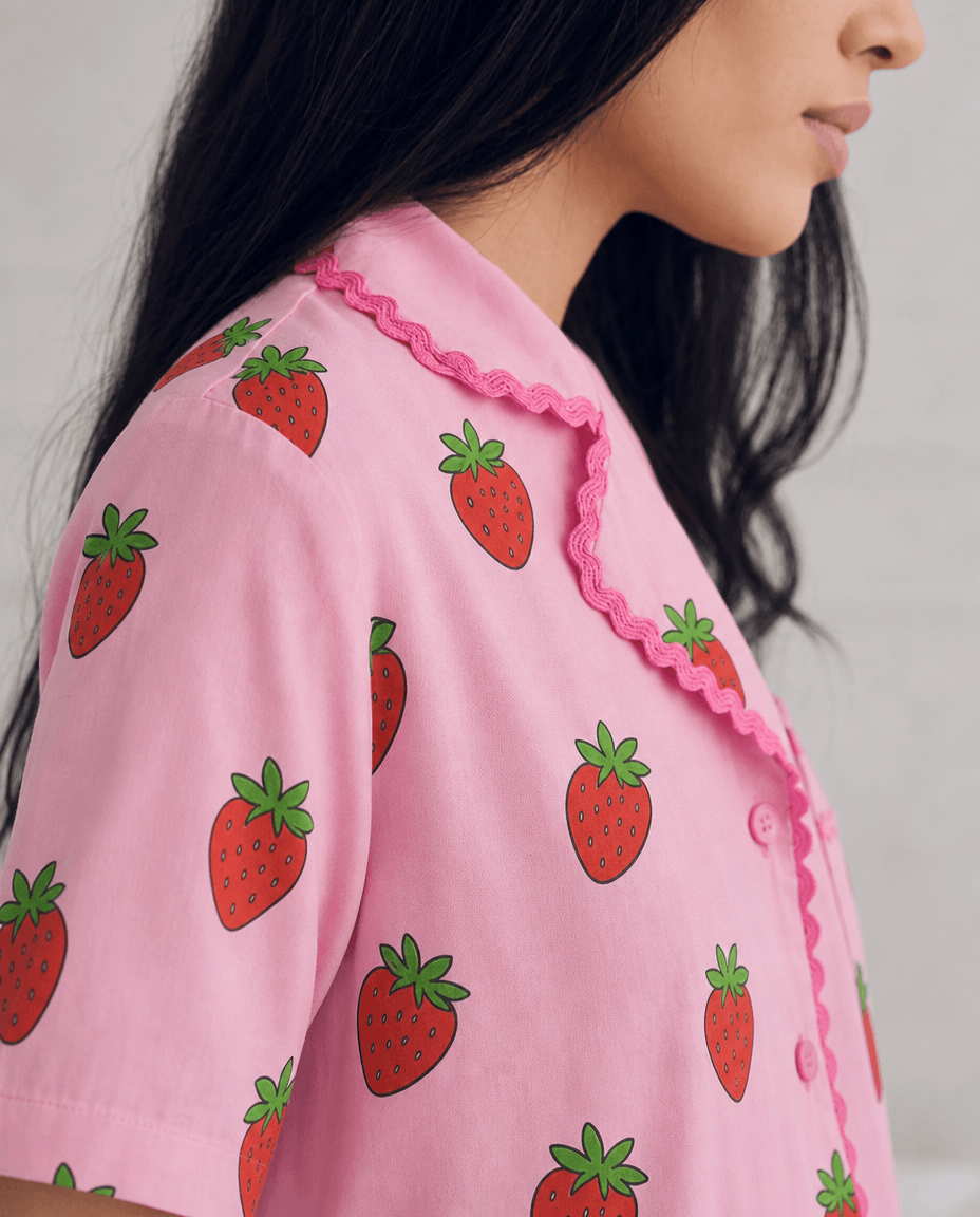 Close view of the Sweet Strawberry pyjama top and scalloped trim.