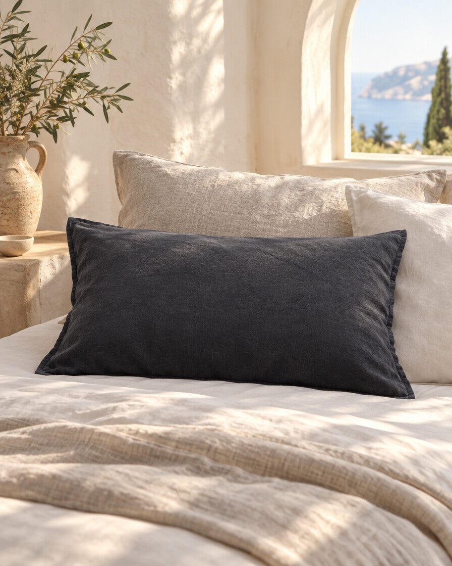 Charcoal French linen pillowcase, styled in a sun-washed Mediterranean bedroom