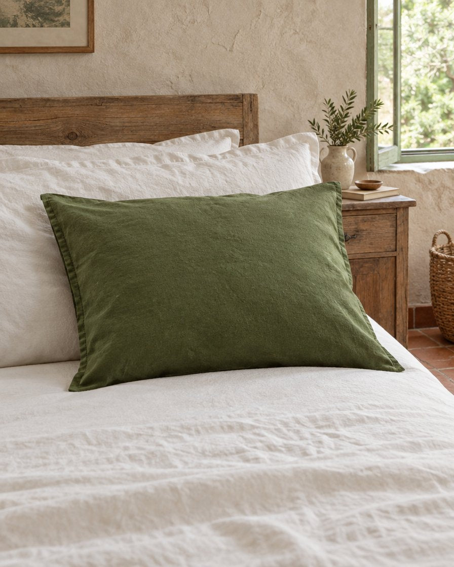 Moss green French linen pillowcase, styled in a relaxed European country-house bedroom