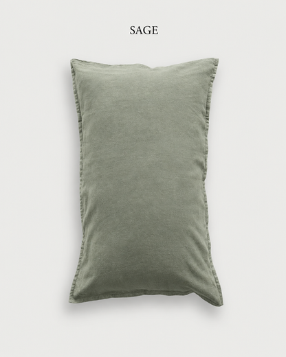 Sage green French linen pillowcase, shown against a pale ground