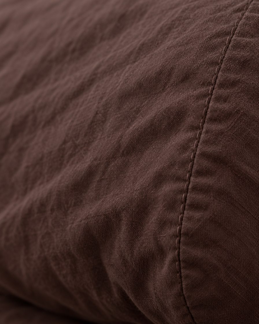 Macro of the stitched seam on a Chocolate pillow in plain cotton pillowcases.