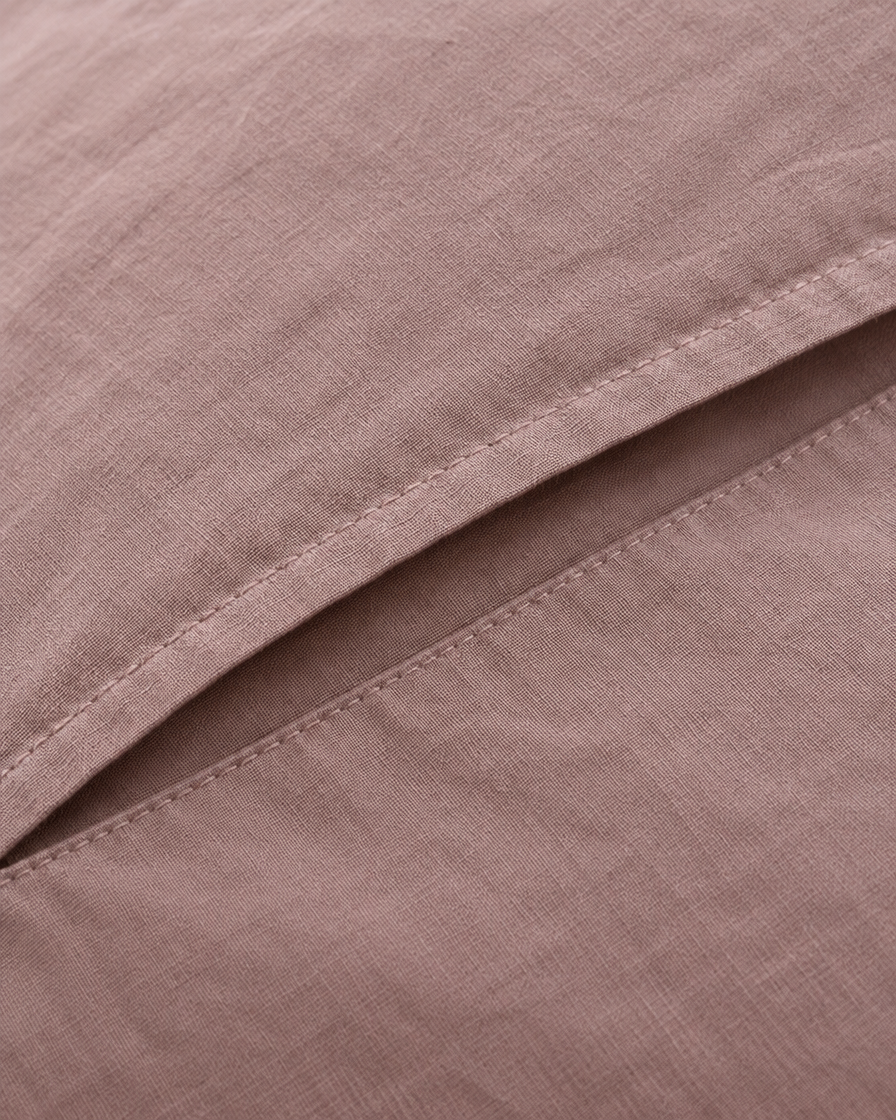 Close-up of stitched envelope opening hem of the pillowcase in Dust Pink Plain Cotton