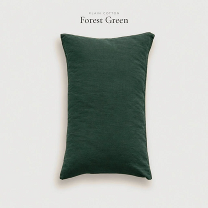 Forest green plain cotton pillowcase in a studio shot on a pale grey background
