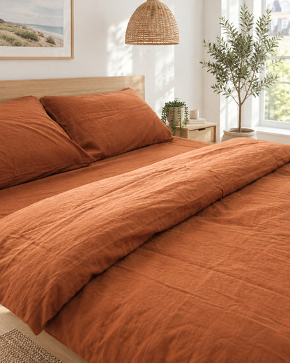 Burnt orange plain cotton bedding, styled in a bright modern townhouse bedroom