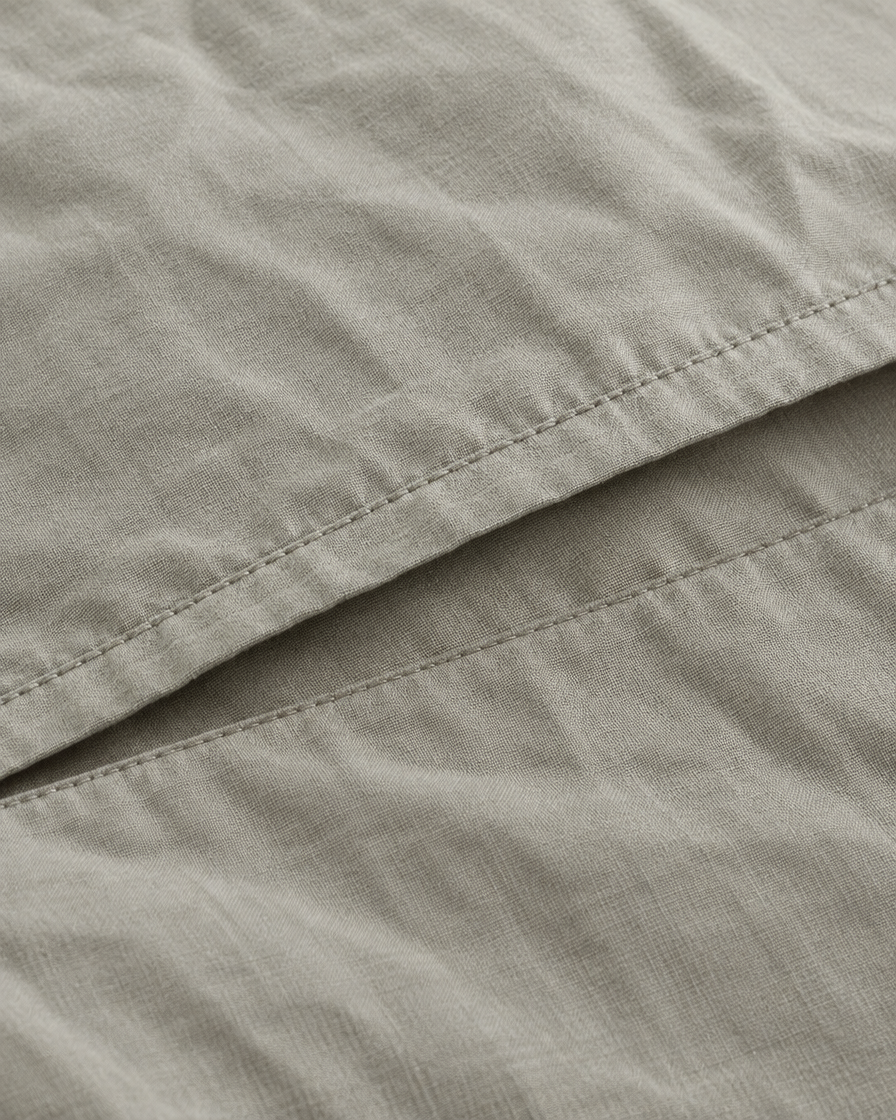Close-up of stitched envelope opening hem of the pillowcase in Mint Grey Plain Cotton