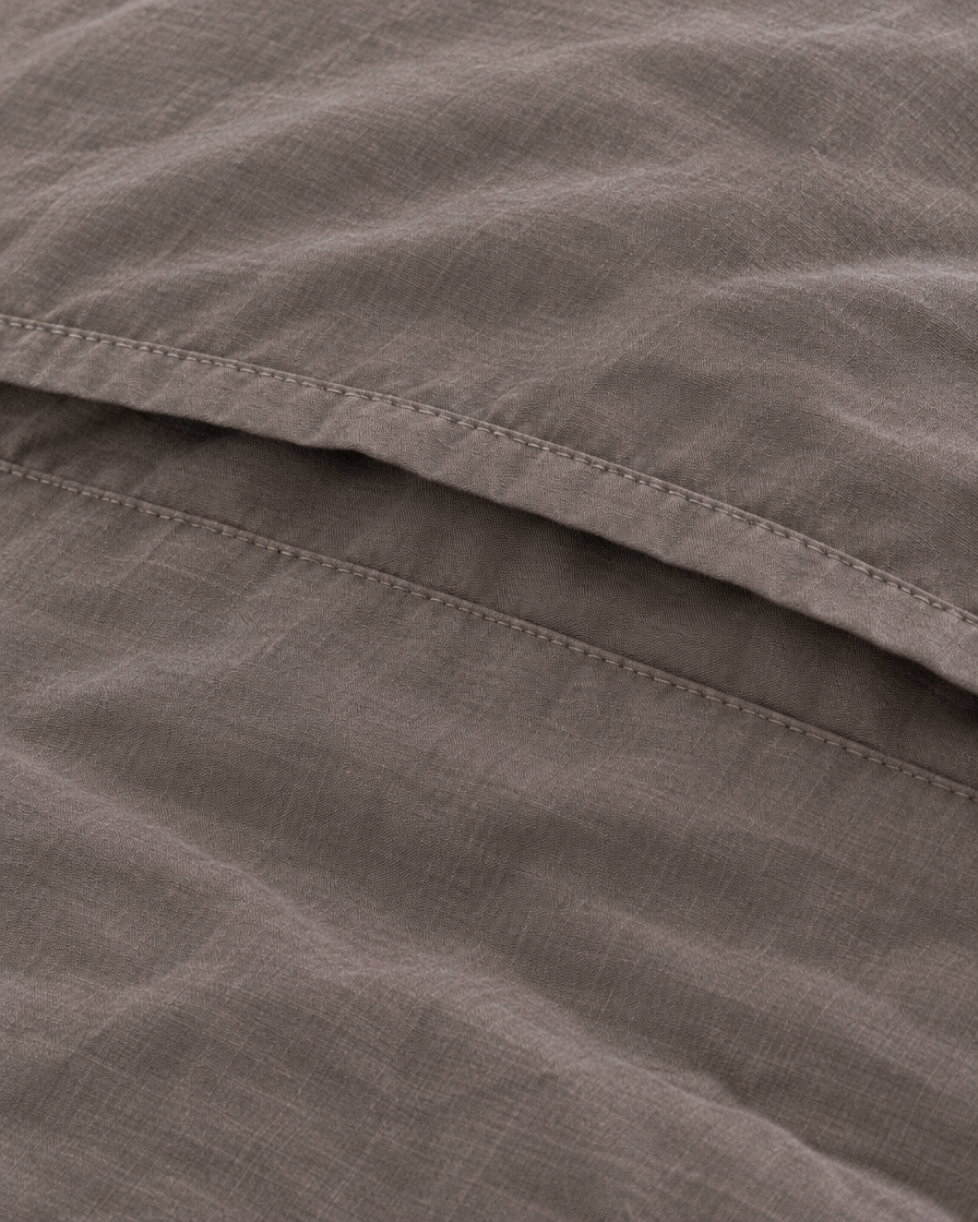 Close-up of stitched envelope opening hem of the pillowcase in Smoke Plain Cotton