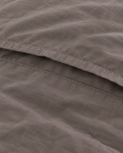 Close-up of stitched envelope opening hem of the pillowcase in Smoke Plain Cotton