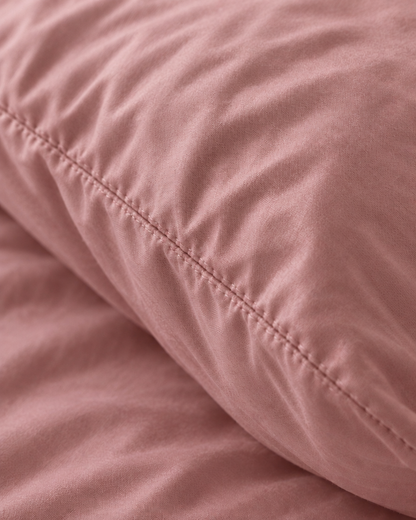 Macro of the stitched seam on a Rose Pink pillow in silky cotton pillowcases.