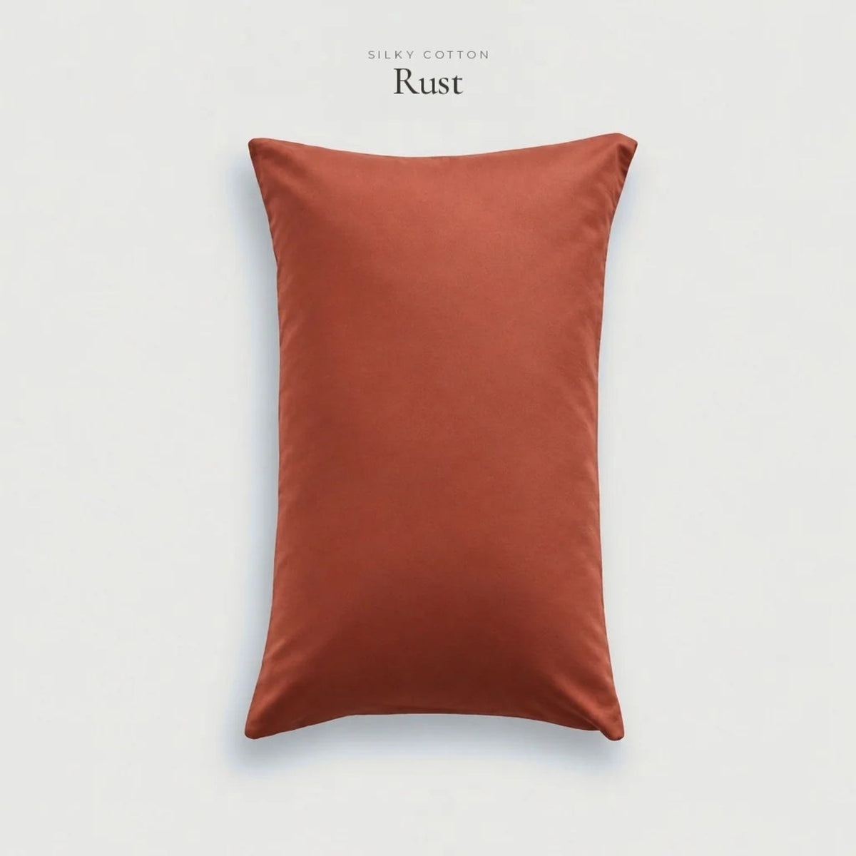 Rust orange Silky Cotton sateen pillowcase standing on a pale grey background