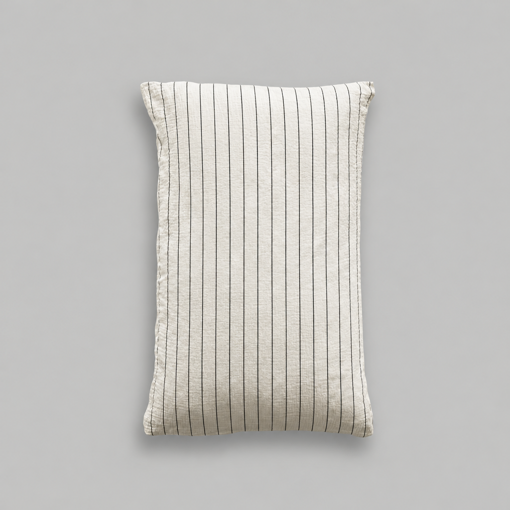 Single cloud cotton pillowcase with crisp Black Pinstripe on off-white crinkled muslin, studio shot.