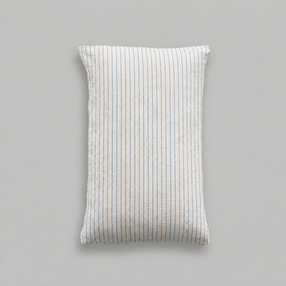 Single cloud cotton pillowcase with fine Blue Pinstripe on soft off-white crinkled muslin, studio shot.