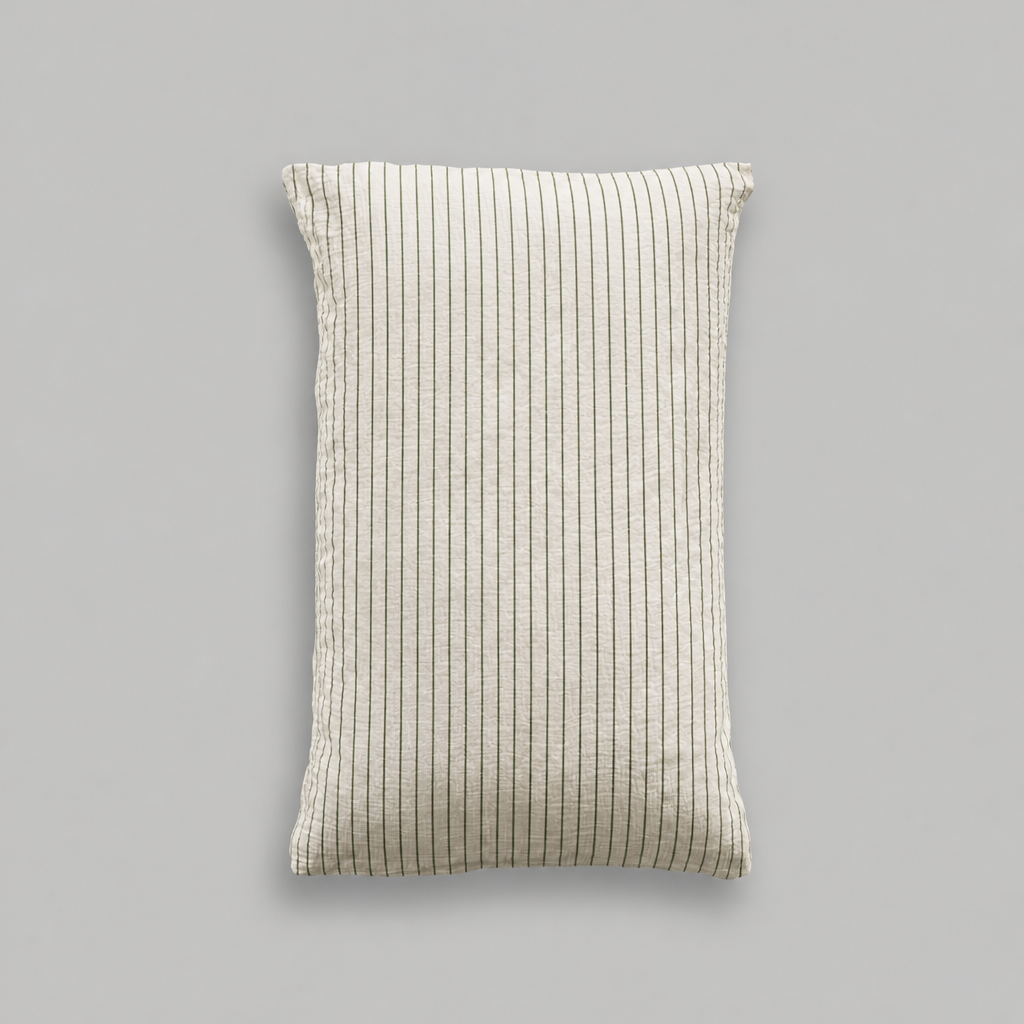Single cloud cotton pillowcase in off-white crinkled muslin with fine Green Pinstripe on a grey studio background.