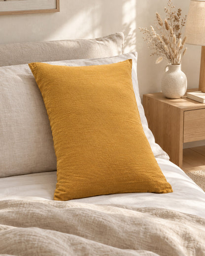 Mustard cloud cotton pillowcase, styled in a calm sunlit Scandinavian bedroom