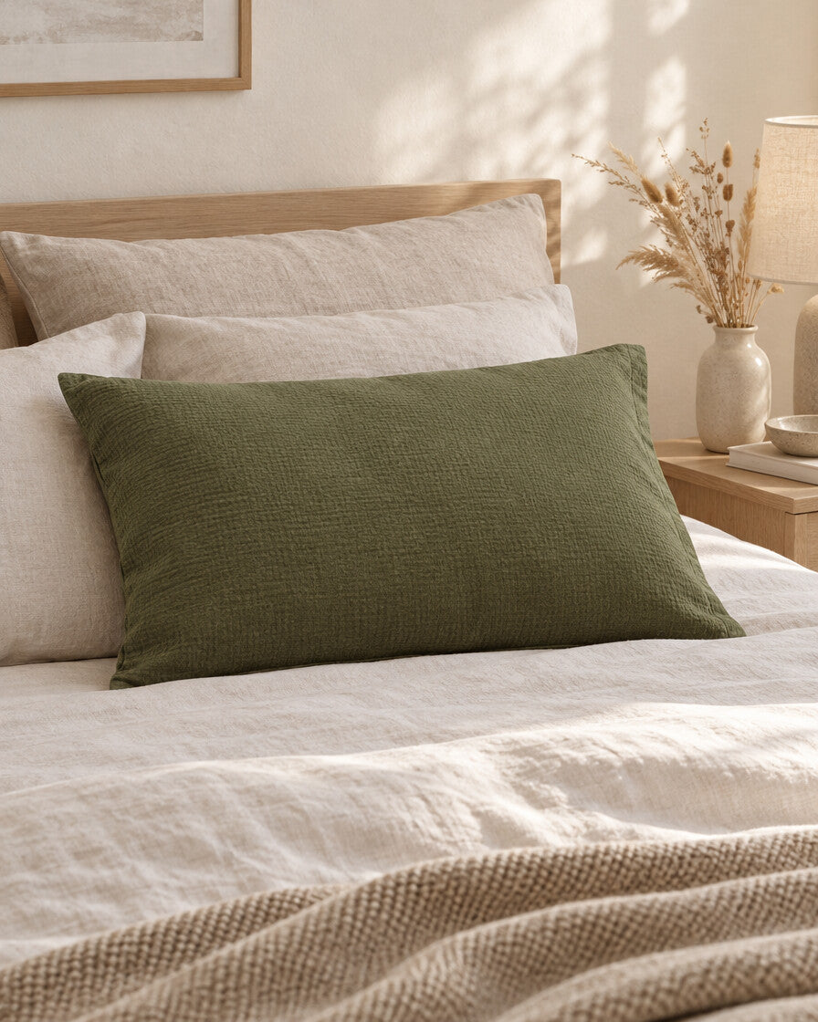 Juniper Green cloud cotton pillowcase, styled in a calm sunlit Scandinavian bedroom