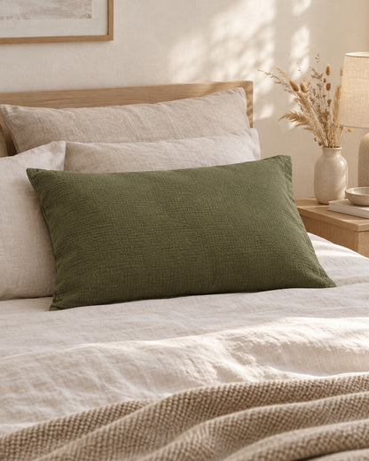 Juniper Green cloud cotton pillowcase, styled in a calm sunlit Scandinavian bedroom