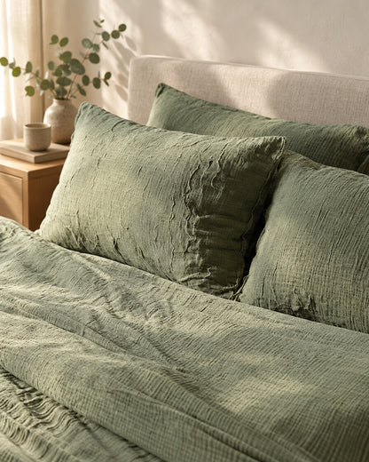 Sage green cloud cotton pillows and duvet, styled in a serene Scandinavian bedroom