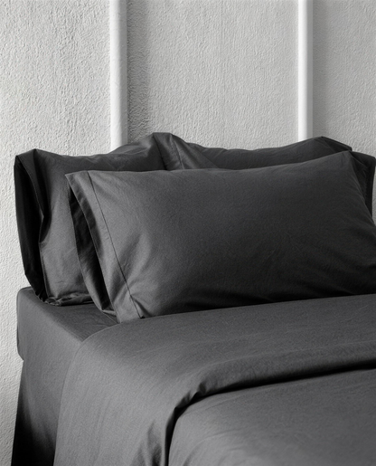 Charcoal Grey silky cotton sateen pillowcases on a bed