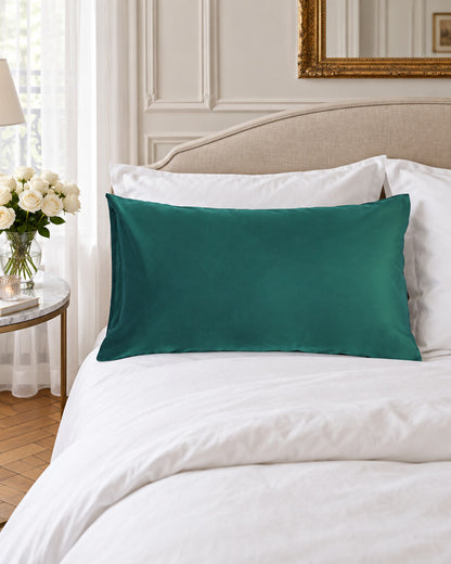 Teal green silky cotton pillowcase, styled in an elegant Parisian apartment bedroom