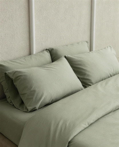 Mint Green silky cotton sateen pillowcases on a bed