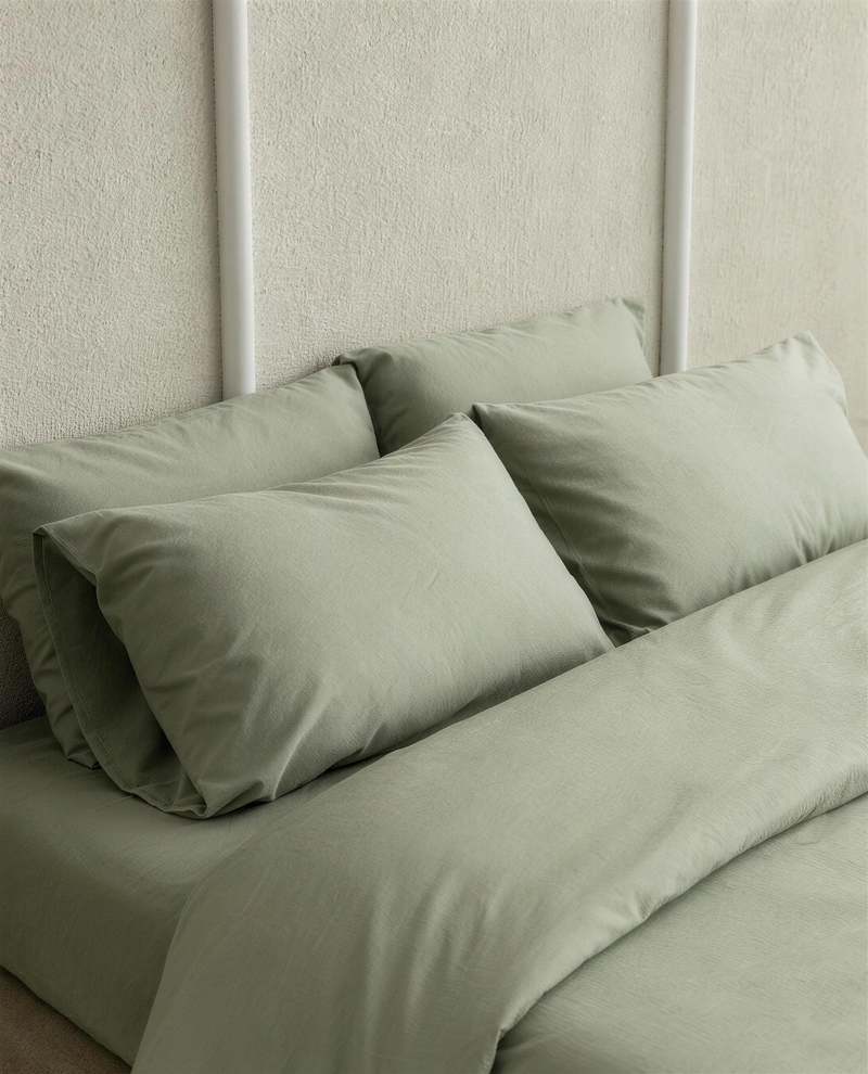 Mint Green silky cotton sateen pillowcases on a bed