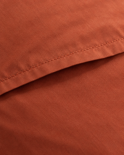 Close-up of stitched envelope opening hem of the pillowcase in Rust Silky Cotton