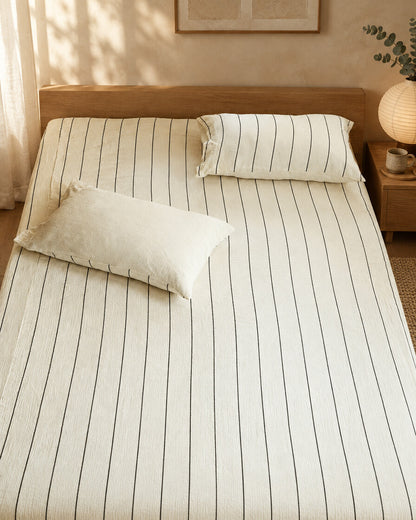 Cream pinstripe cloud cotton fitted sheet and pillow, styled in a serene Japandi bedroom