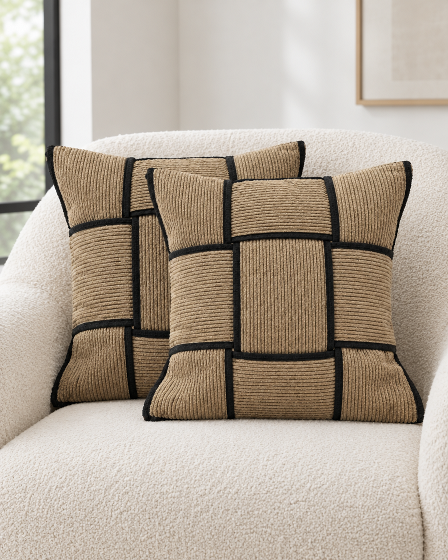 Two khaki and black Basket Weave cushion covers on a cream bouclé armchair
