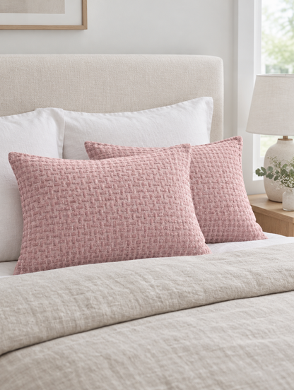 Dusty pink basketweave rose jacquard cushions on an oatmeal linen duvet