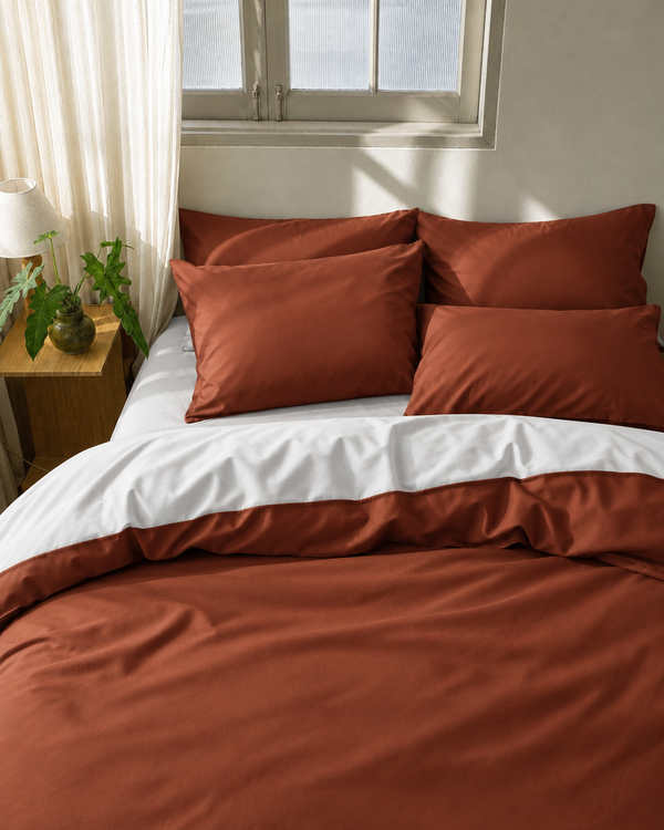 Rust duvet cover with milky white reverse, milky white fitted sheet and rust pillowcases in Silky Cotton