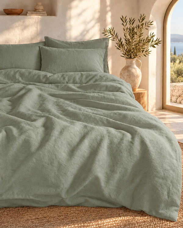 Bedding set in Sage, French linen, on a made bed
