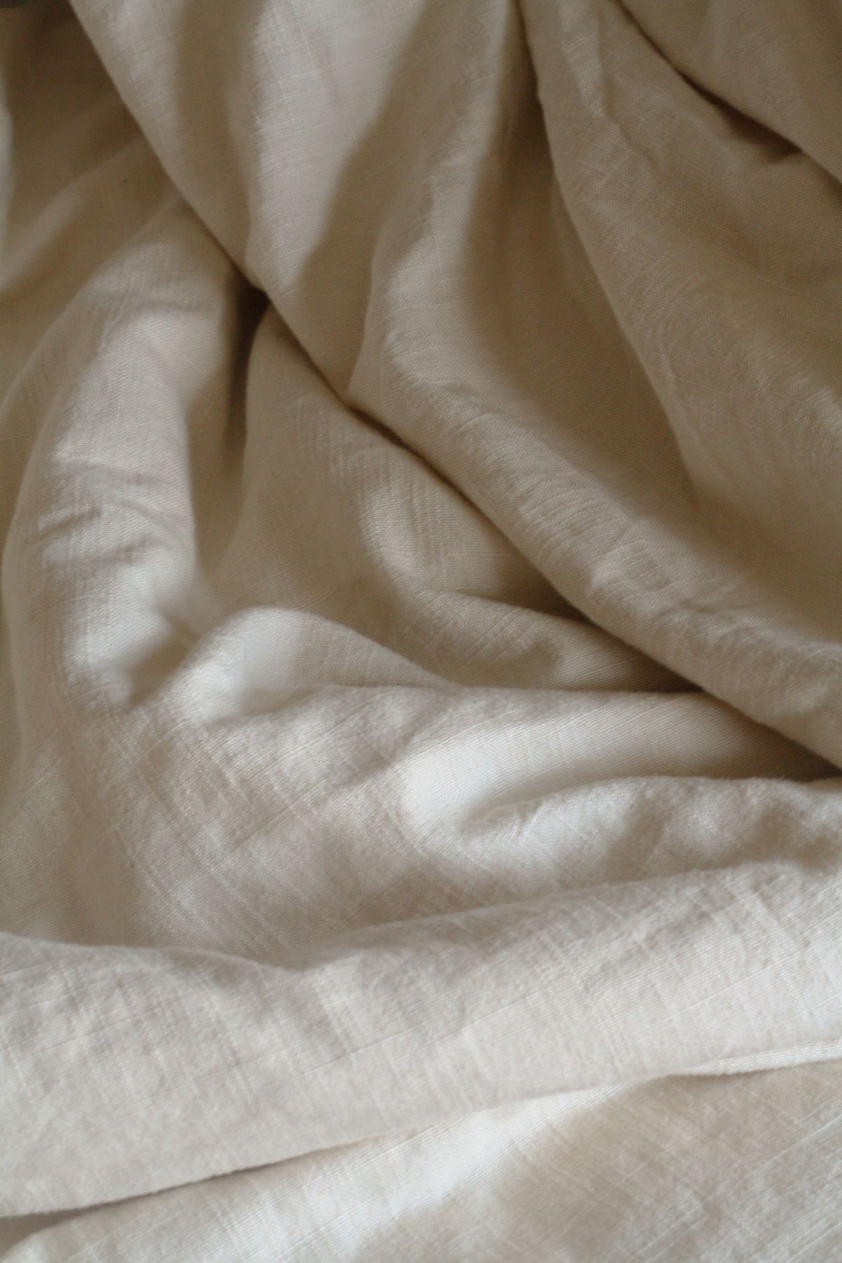 Close-up of oatmeal linen in soft folds