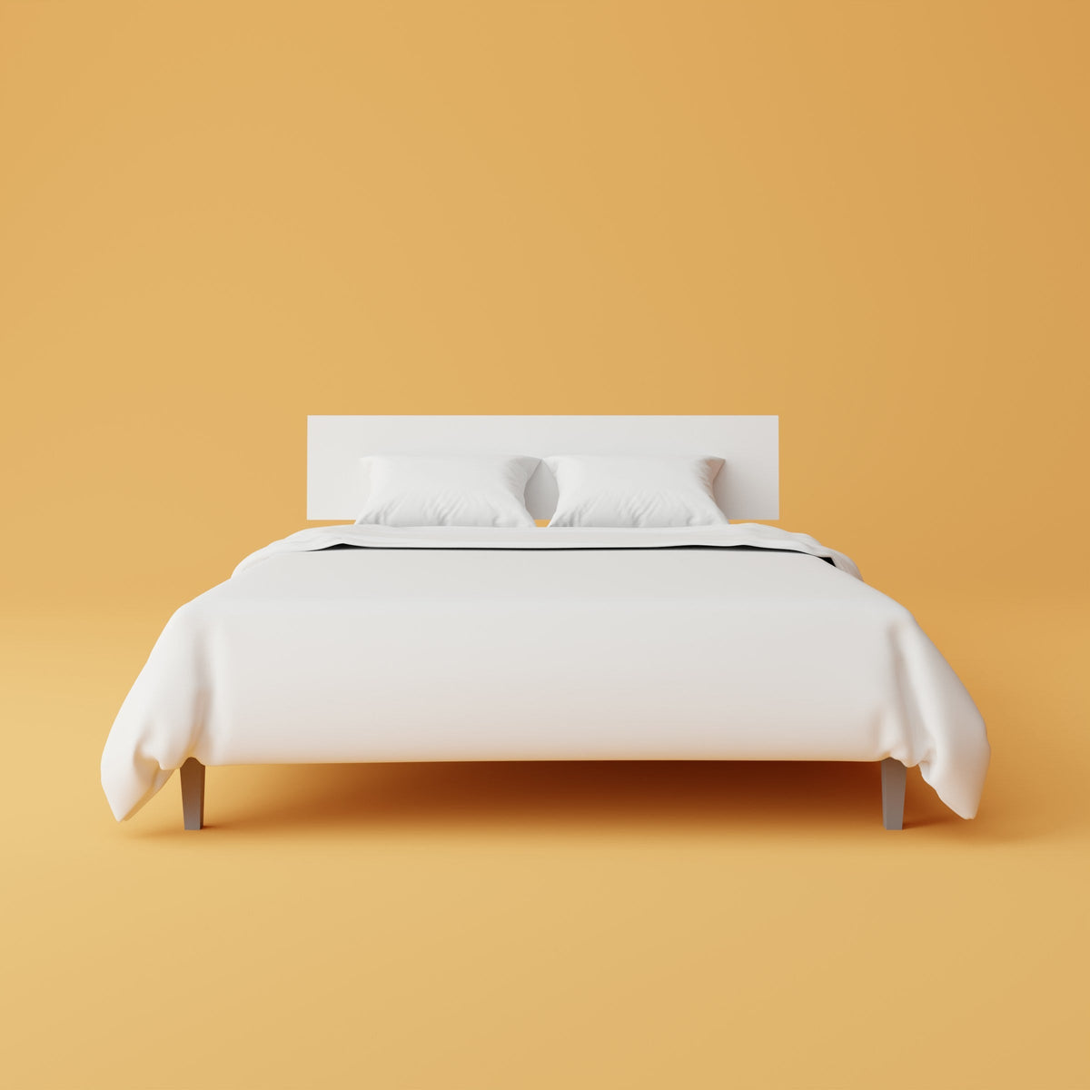 A bed dressed in plain white bedding photographed against a warm ochre background.