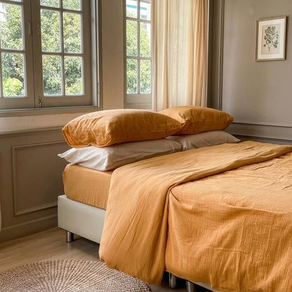 Mustard cloud cotton duvet cover styled on a bed