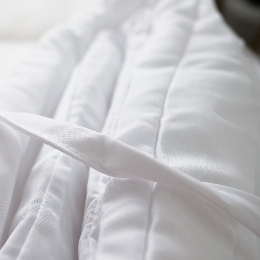 Close view of the duvet insert's box stitching and corner tab.