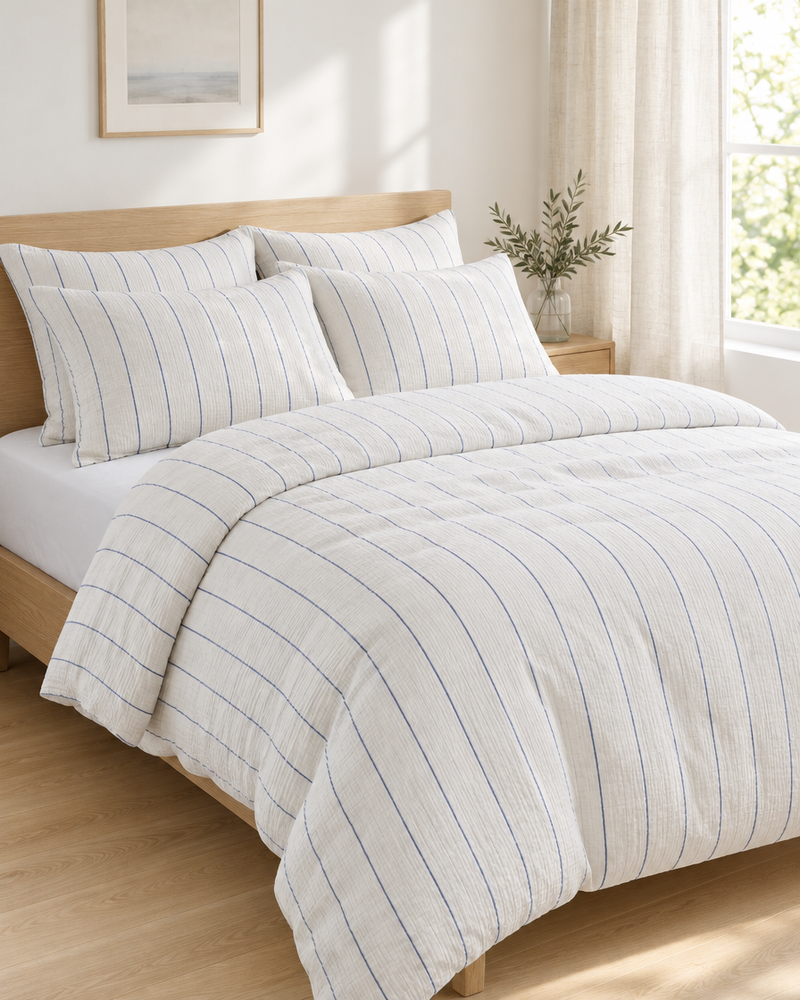 Blue pinstripe Cloud Cotton double gauze bedding on a made double bed