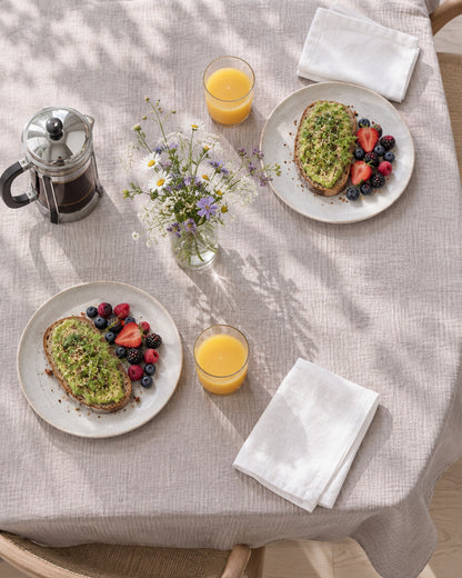 Soft neutral cloud cotton tablecloth laid for brunch, seen from above