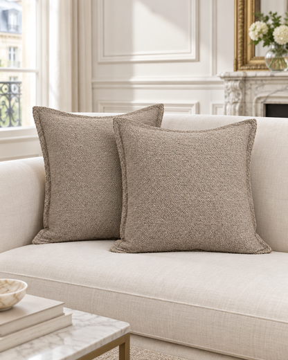 Taupe heathered jacquard cushion covers with a flat flange on a pale sofa in a panelled Parisian room