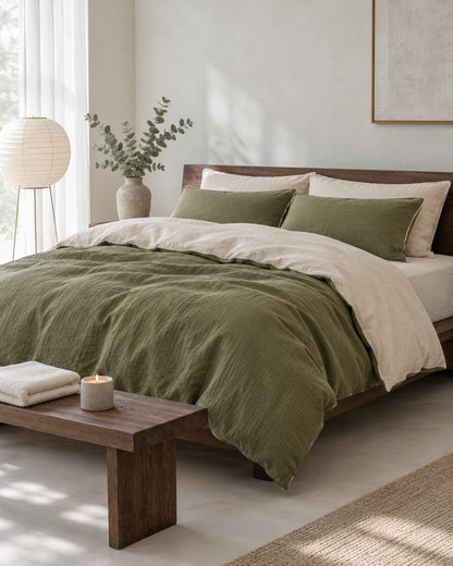 Olive green and cream two-tone cloud cotton bedding in a calm Japandi bedroom on a low dark-oak bed