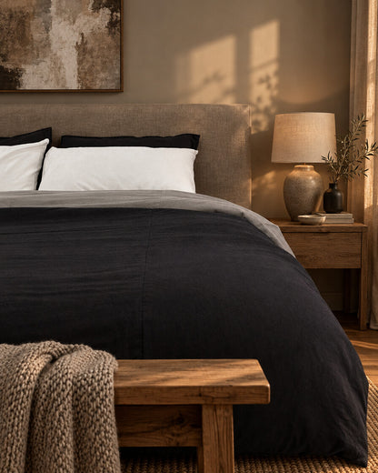 Two-tone plain cotton bedding in charcoal and white, styled in a cosy contemporary bedroom