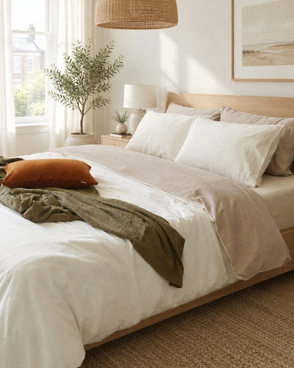 Two-tone plain cotton bedding in cream, styled in a bright modern townhouse bedroom