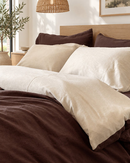 Chocolate brown and cream two-tone plain cotton bedding, close view of the turned-back duvet