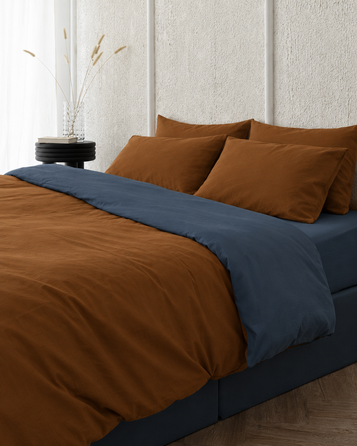 Two tone Plain Cotton duvet cover in Cinnamon folded back to show a blue jeans reverse