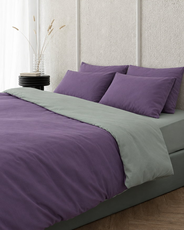 Two tone Plain Cotton duvet cover in Lavender folded back to show a mint grey reverse