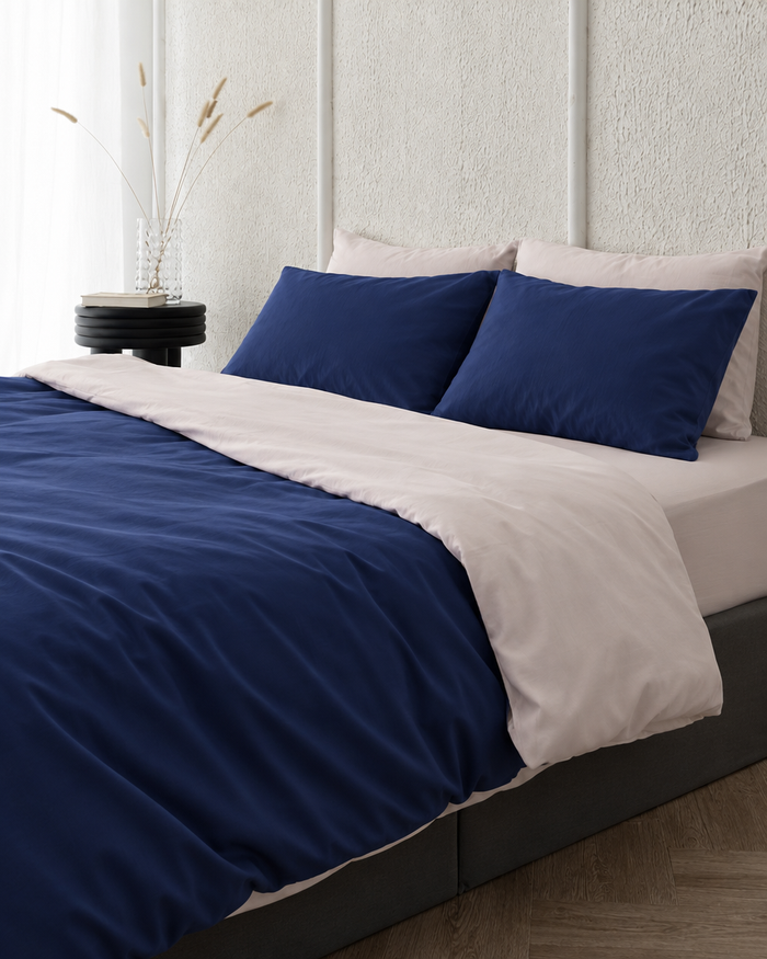 Two tone Silky Cotton duvet cover in Marine Blue folded back to show a peach reverse