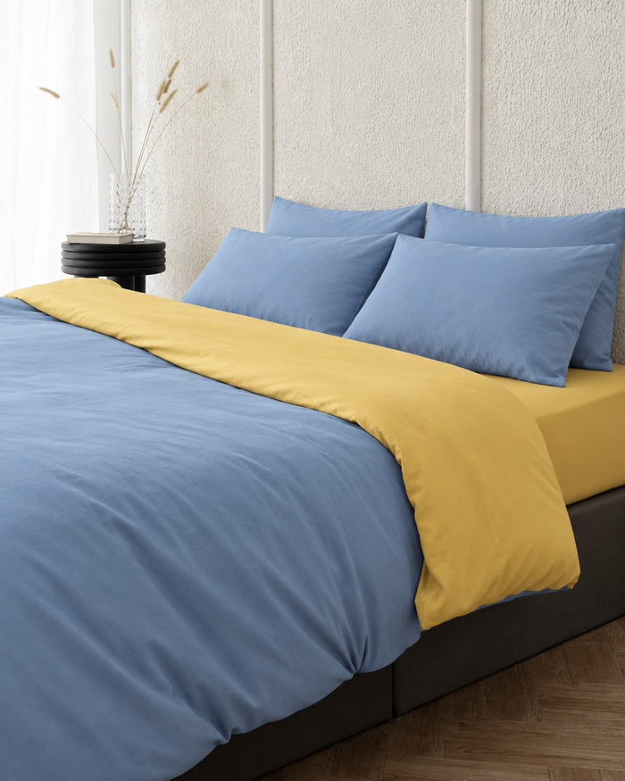 Two tone Plain Cotton duvet cover in Sky Blue folded back to show a butter reverse